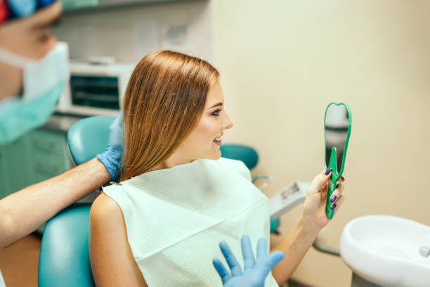 Dentist showing result of treatment for the patient